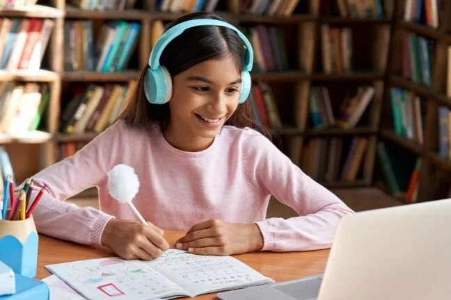 Female middle school student at laptop
